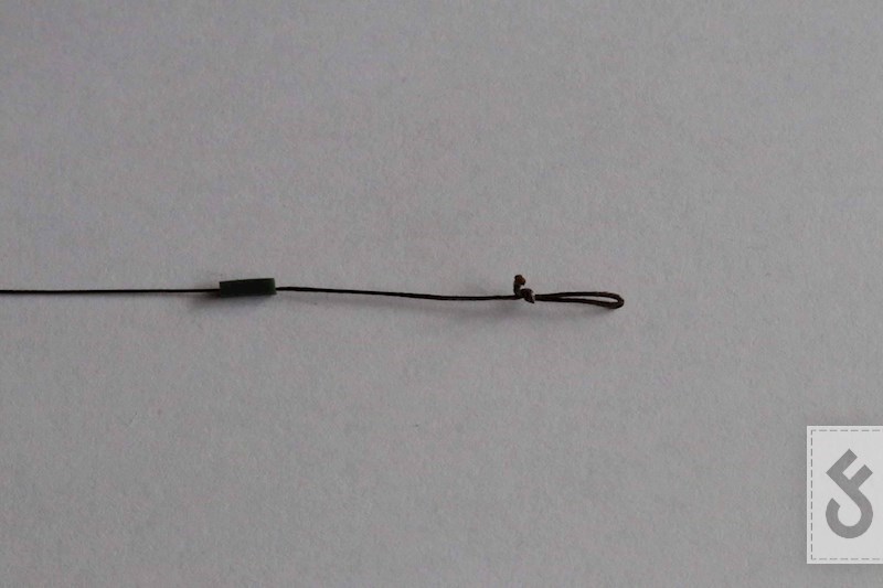 Schuif een klein stukje siliconen tube over het onderlijnmateriaal voor het positioneren van de hair